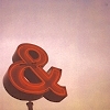 Red ampersand sign in front of pink clouds.