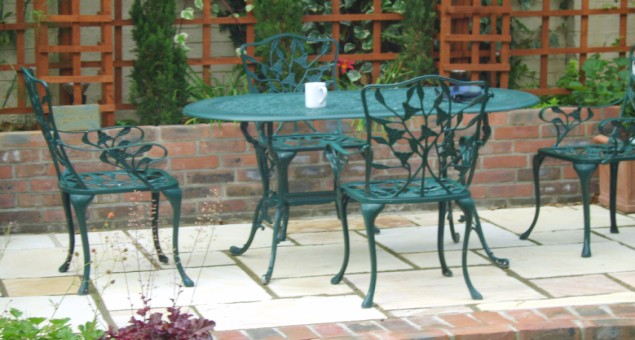 A pretty seating area for al fresco dining was created to the back of the garden to catch the evening sun and a feature was made of the high boundary wall by adding trellis work, structural conifers and climbers.