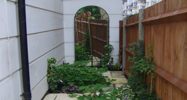The neglected side return was given some interest by adding a perspective mirrored arch and softened with planting. 