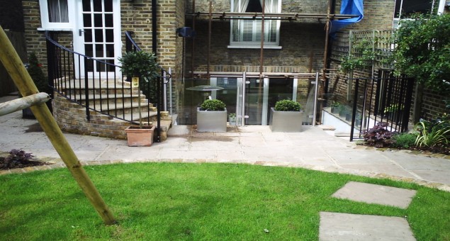 To allow more light into the kitchen and to provide a useable space for outdoor dining, the well area was extended outwards by some 3.5 metres. Bi-fold doors were also added and the contemporary feel of the interiors was continued outside with the use of painted rendered walls, glass and steel balustrades, and beautiful natural sandstone. 