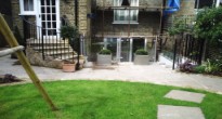 Garden with glass balustrades and bifold doors