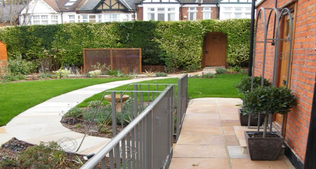 The first step in the front garden was to remove the vast expanse of concrete and paving, and to re-route the path from the pavement to the front door so that the door is approached ‘head-on’ rather than from the side. This makes for an altogether more imposing and welcoming entrance. 