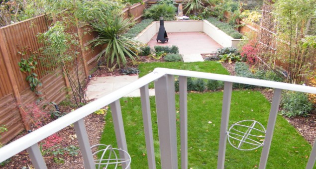 Next to the house a pergola covered balcony affords great views down over the whole garden. A decked area surrounded by raised beds with perfumed planting and a natural stone water feature sits at the end, making use of the awkward angles.
