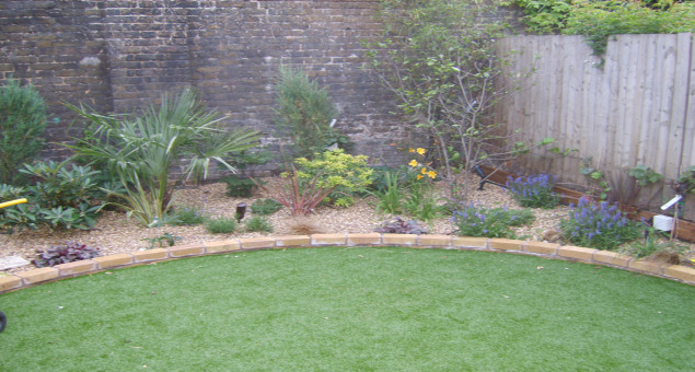 A circular area of lawn tricks the eye as to the width of the garden. As the previous lawn never flourished, and in the interests of low maintenance, we laid artificial turf to make an excellent play surface for the children. 