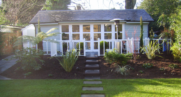 A large rectangular lawn was laid with a stepping stone path leading to the summerhouse, and to either side sleeper raised beds provide planting beds accessible and easy to work, but protected from children and dogs alike! 