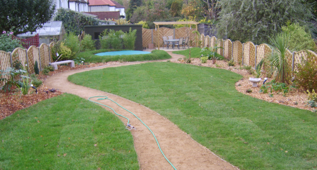The garden was given a pleasing curvy design to disguise its length, with a practical hoggin path leading the eye back and forth across the space. 