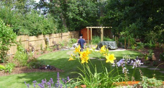 At the end of the path lies a large circular sandstone patio sheltered by a semi-circular pergola over which scented climbers will in time clamber. The pergola partially conceals the wild garden to the rear with its wild flower meadow, woodland and carefully placed tree seat. 