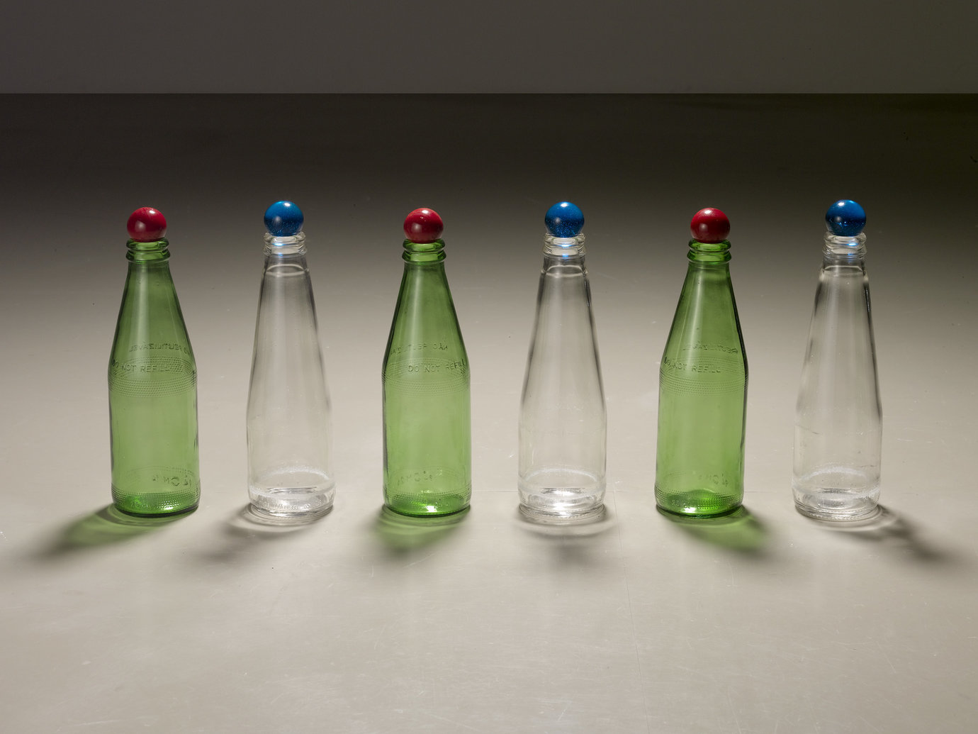 , 2007. Glass bottles, glass marbles, 8" x 20" x 2" (20.3 cm x 50.8 cm x 5.1 cm).