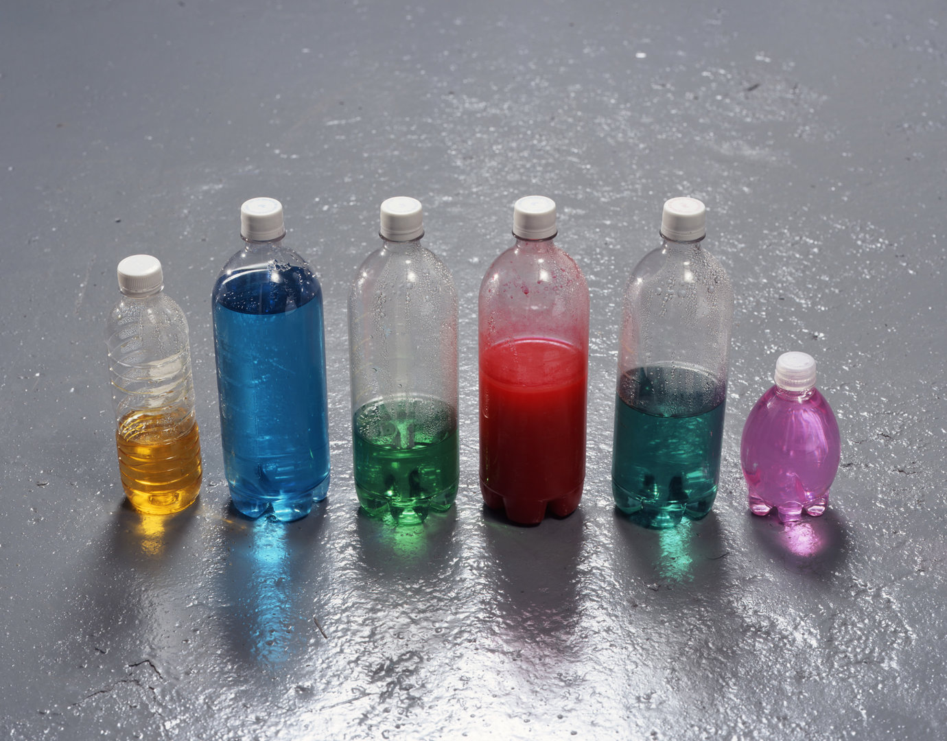 , 2007. Plastic bottles with screw caps, food coloring, ink, water, overall installation dimensions variable
10-1/2" x 26" x 3" (26.7 cm x 66 cm x 7.6 cm).