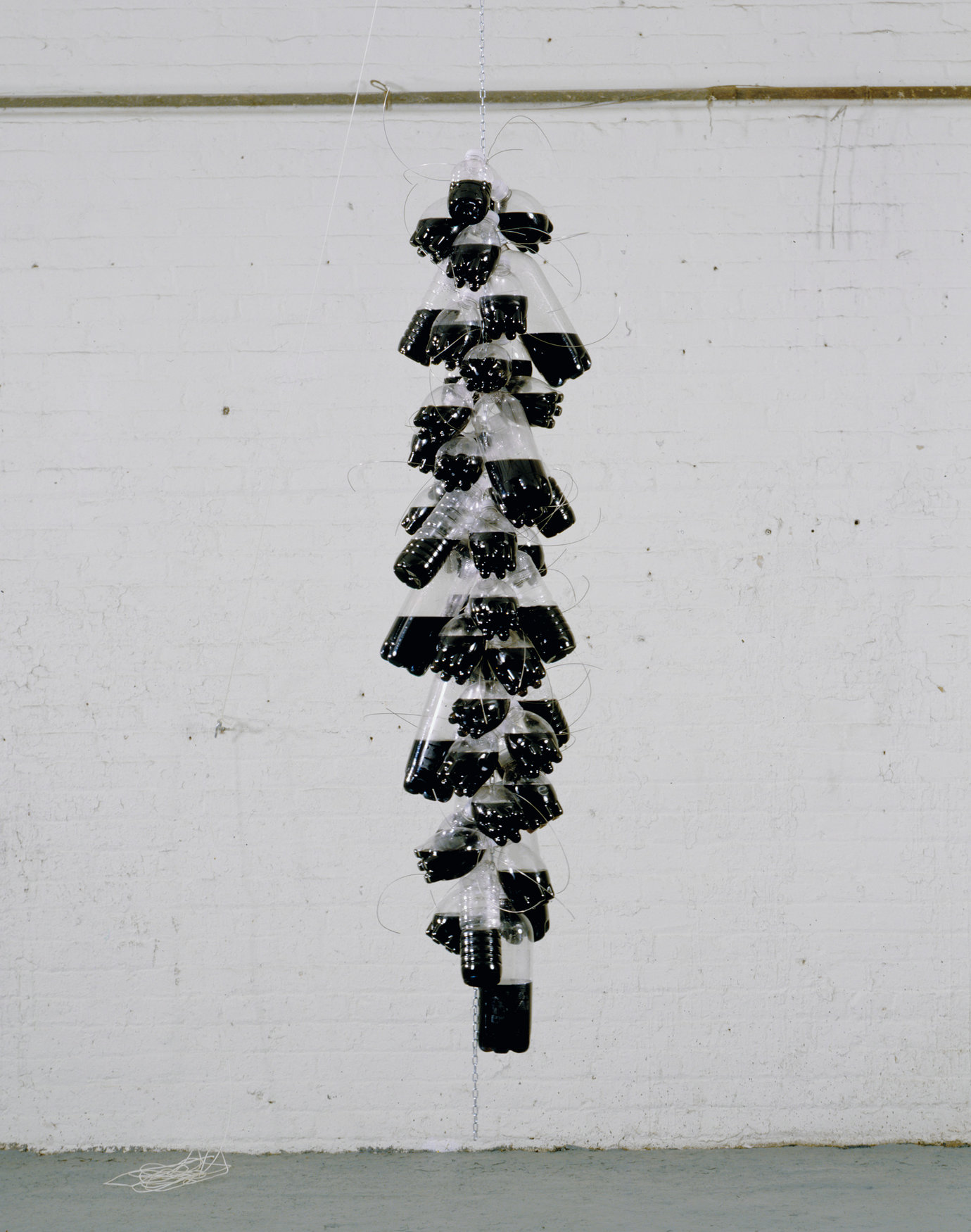 , 2007. Plastic bottles with screw caps, india ink, water, stainless steel wire, chain, 84" x 16" diameter (213.4 cm x 40.6 cm).