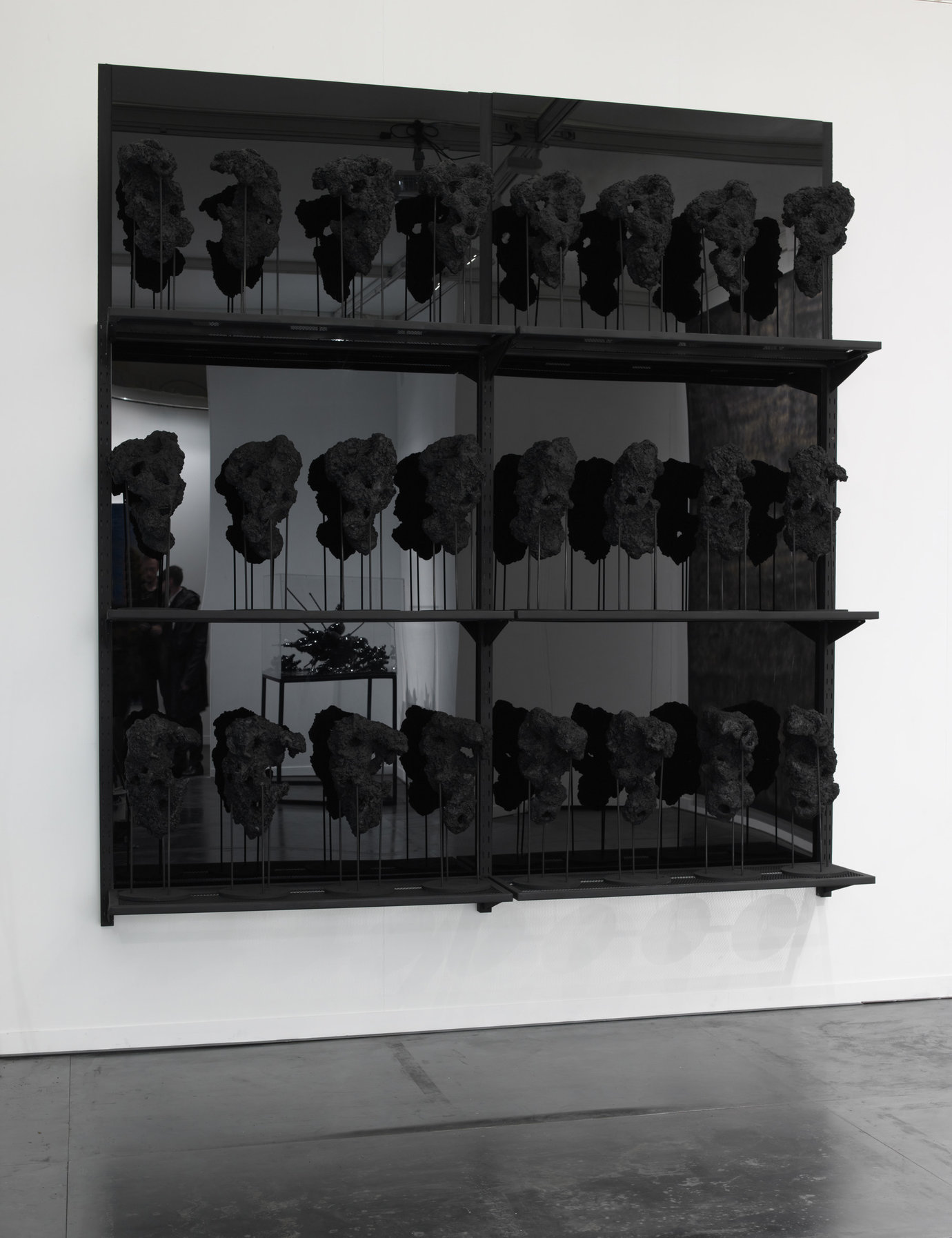 , 2011. Black wax, carbon, molded rocks, resin, steel pedestals.