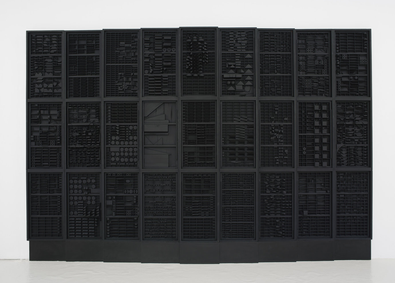 , 1973. Wood painted black, 8' 5-1/4" x 13' 10" x 6" (257.2 cm x 421.6 cm x 15.2 cm), 9 elements plus 2 part base, 11 parts total.