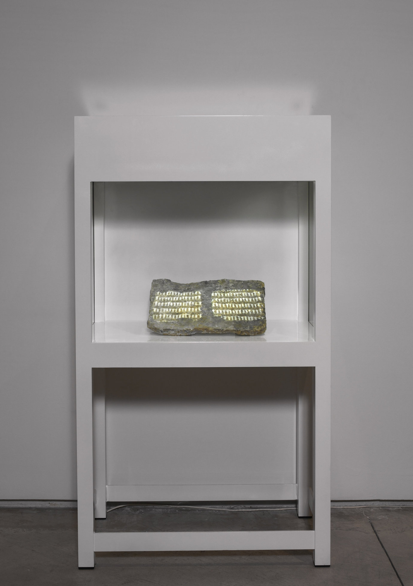 , 2004. Steel vitrine with glass, stone and video projection, 57-1/8" x 32" x 20" (145.1 cm x 81.3 cm x 50.8 cm).