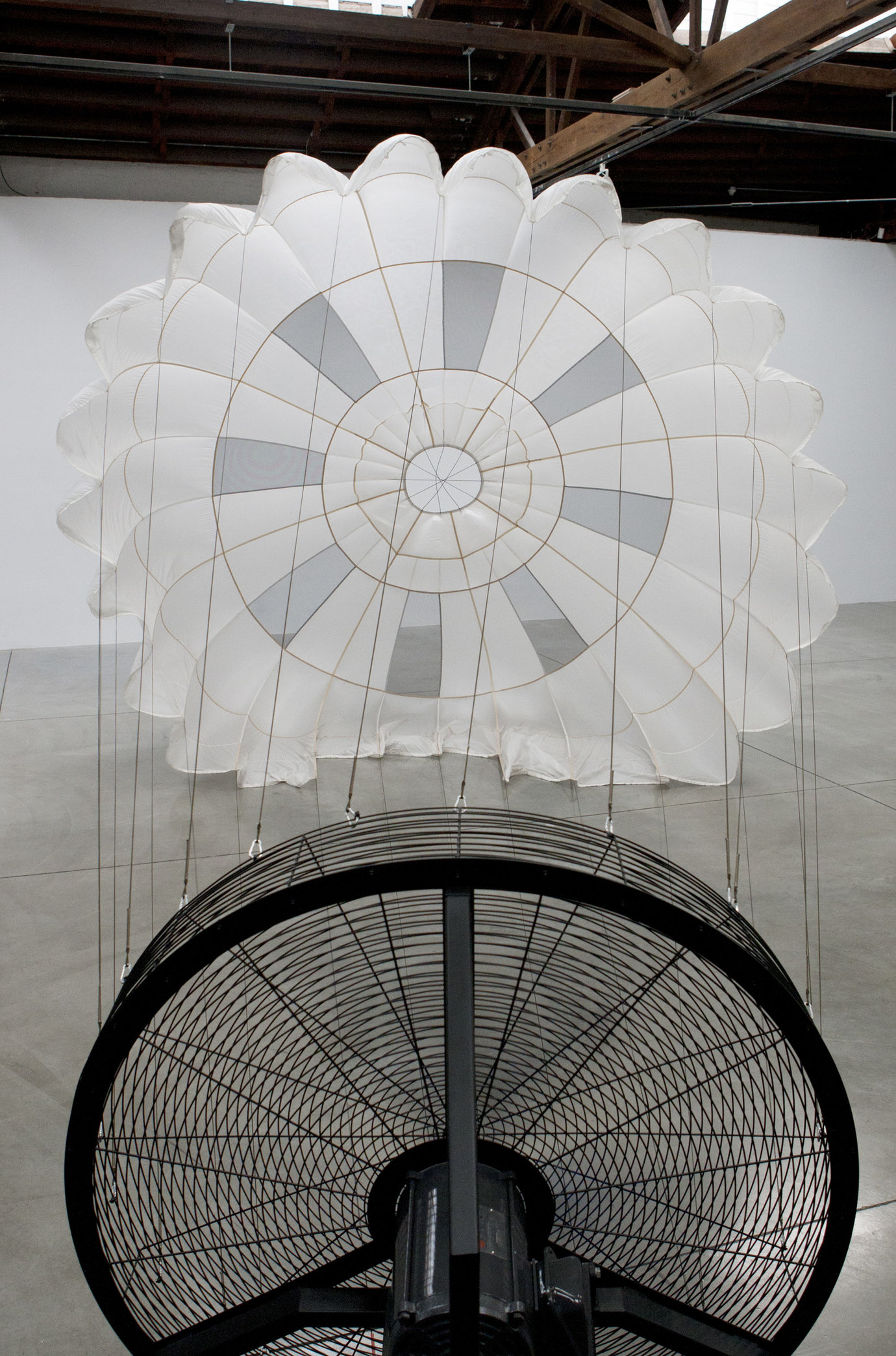 , 2011. Parachute, wind machine, sound proof paneling, installation dimensions variable, site specific.