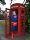 Superman does a quick change in the  trusty phone box...