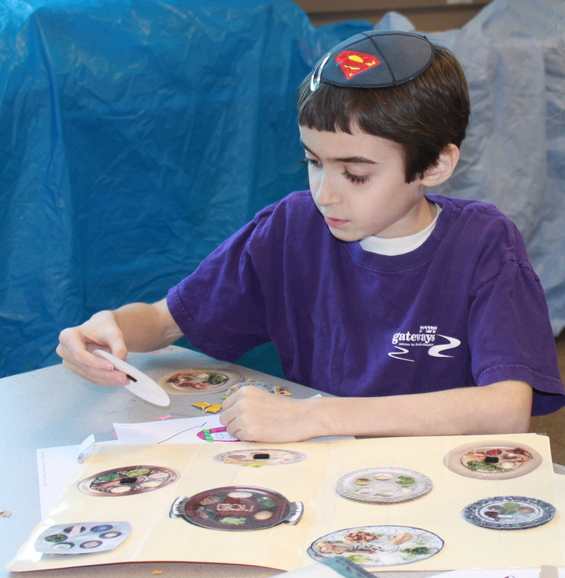 Jacob completes a seder plate file folder activity