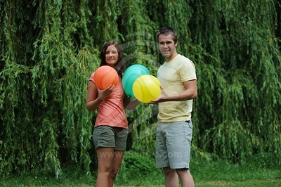 Young couple holding balloons picture