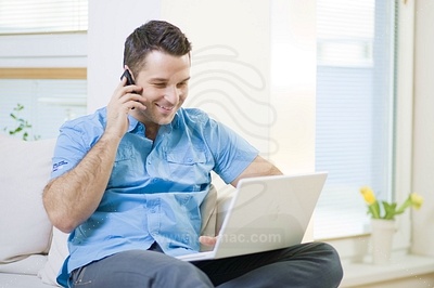 Young Man Working on PCфотография