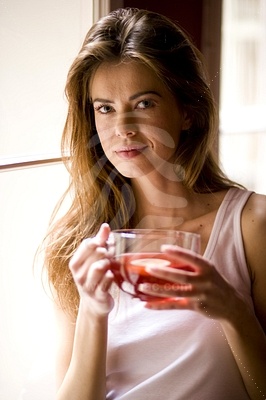 Young Woman Holding Cup of Teaфотография