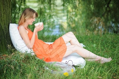 Young Woman in Orange Summer Dressфотография