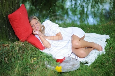 Young Woman Lying on Grassфотография