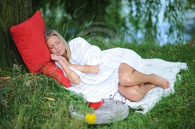 Young Woman Sleeping on Grassфотография