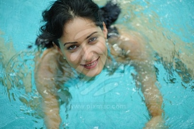 Young Woman Swimming in the Pool picture