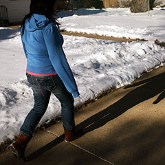 Caption: Brenda, 19, walks through her Minneapolis neighborhood. She's been living as an illegal immigrant in Minnesota since she was 7 years old., Credit: MPR Photo/Jeff Thompson