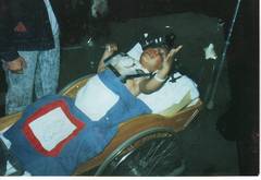 Caption: LJ Thomas in wheelchair and halo, soon after his accident.