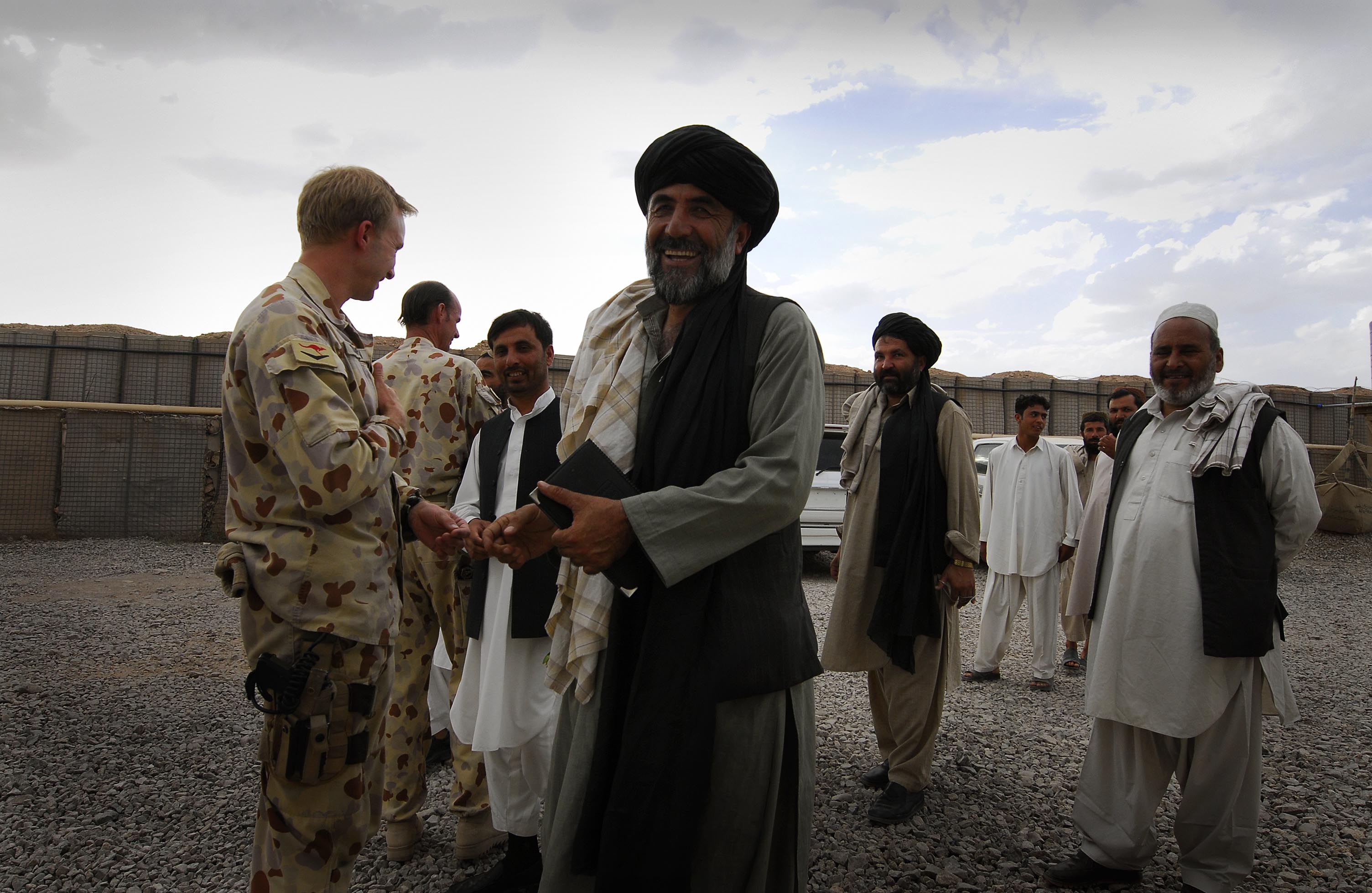Caption: Australian Officers from the 1st Mentoring and Reconstruction Task Force welcome local government and building industry representatives to a celebratory ceremony and meal held at the main Australian base in Oruzgan Province. , Credit: Corporal Ricky Fuller