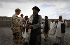 Caption: Australian Officers from the 1st Mentoring and Reconstruction Task Force welcome local government and building industry representatives to a celebratory ceremony and meal held at the main Australian base in Oruzgan Province. , Credit: Corporal Ricky Fuller