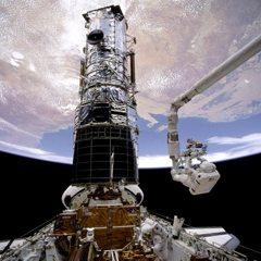 Caption: Jeff Hoffman working in the shuttle's cargo bay, Credit: Nasa