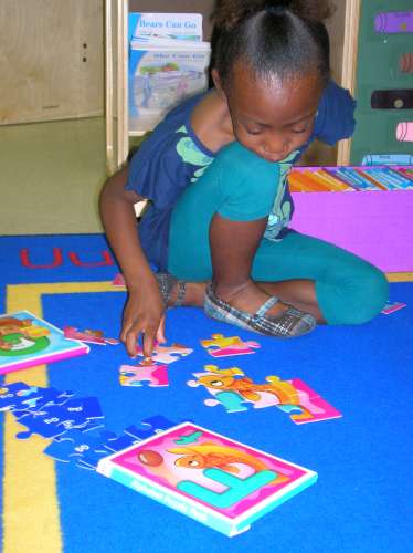 Caption: A student in a preschool classroom at River Breeze Elementary, a public school in Palatka, Florida. Preschool used to be a radical idea, but now the majority of American children go to preschool. , Credit: Stephen Smith