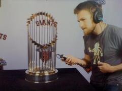 Caption: Producer Max Jacobs with the World Series trophy