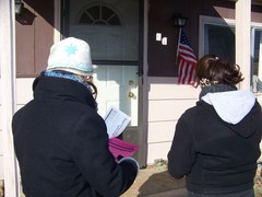 Caption: Community activist "Maria" hands out flyers door-to-door in Outlook, Wash., Credit: By Anna King.