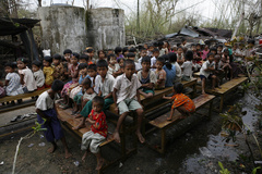Caption: Children congregate outside a school that serves as a temporary camp for those displaced by the cyclone, near the town of Kundangon in the south-western Irrawaddy Division. The children lost their homes, and much of the school was destroyed., Credit: UNICEF/NYHQ2008-0340/Dean