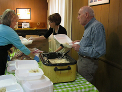 Caption: Rebecca Barrett and the Klines serving lunch, Credit: Philip Graitcer