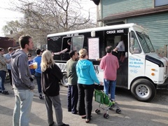 Caption: People line up outside the Dim and Den Sum food truck for gourmet tacos and kimchi mac and cheese. 