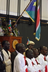 Caption: Veterans of the Second Sudanese Civil War stand under the new flag of South Sudan., Credit: Alyce Ornella