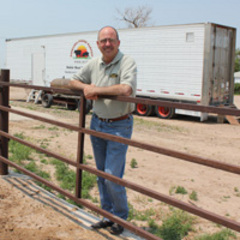 Caption: Mike Callicrate owns a feed yard in St. Francis, Kan. where the mobile meat processing unit currently resides. Owned by the Nebraska Environmental Action Coalition, the slaughter unit has been tested on Callicrate’s northwest Kansas property since last fa, Credit: Eric Durban / Harvest Public Media