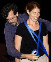 Caption: Wes Hamilton, left, wraps Allison DeNio with blue duct tape forming the letter "X" standing for ex-wife during a rehearsal for the play "The Divorce Revolution" on Tuesday, July 26, 2011, at the Valencia Art Center in Winona. The play, in which both act a, Credit: Alexa Wallick/Winona Daily News