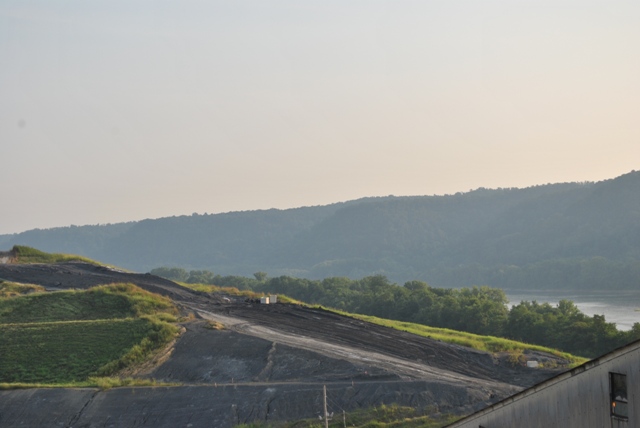 Caption: The ash landfill, partially covered with grass, at Louisville Gas & Electric's Cane Run Power Station in Louisville., Credit: Erica Peterson