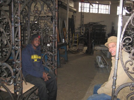 Caption: Sharay Kodihem (left) and Carlos Nielbock (right) sitting in the trellis they made together