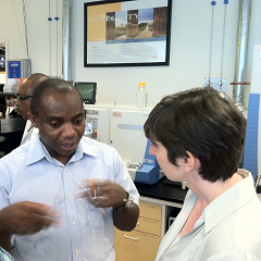 Caption: Seeding Labs' founder Nina Dudnik speaks with a visiting African fellow during a laboratory tour., Credit: Anne Allmeling