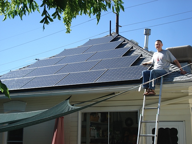 Caption: Kevin Shumway shows off his rooftop solar PV array., Credit: Kevin Shumway
