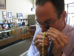 Caption: Jacob Notowitz examines a gold chain at Numis International. , Credit: Callie Shanafelt