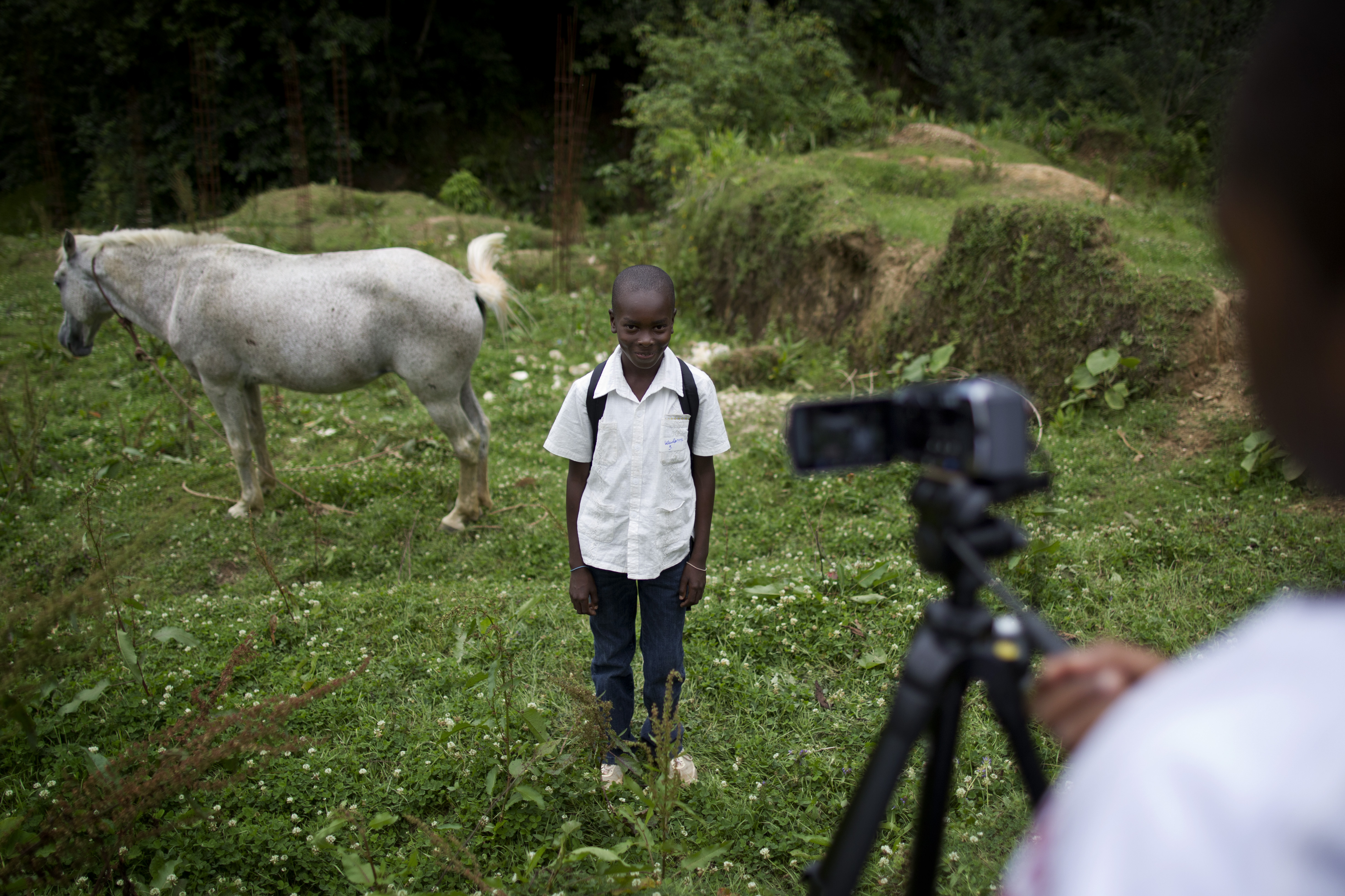 Caption: Two adolescence participating in the creation of a one-minute video in Kenscoff, a community near Port-au-Prince, Haiti., Credit: UNICEF/NYHQ2011-2121/Dormino