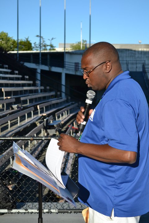 Caption: Marcus Pimpleton directing at an All-City Band Rehearsal in Memorial Stadium., Credit: Kristin Viray