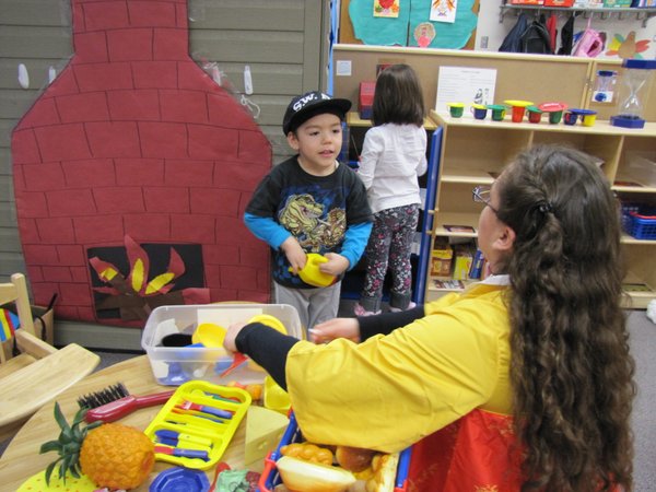 Caption: Sandra Reynoso takes a turn volunteering in her son Julian's pre-kindergarten classroom at Rundle Elementary School in Las Vegas. Parental involvement is a major focus of the program. , Credit: Jude Joffe-Block