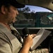 Caption: Patrick Michael FInn reads and interviews from the driver's seat of his car at a Circle K in Mesa, AZ, Credit: Robert Hoekman Jr